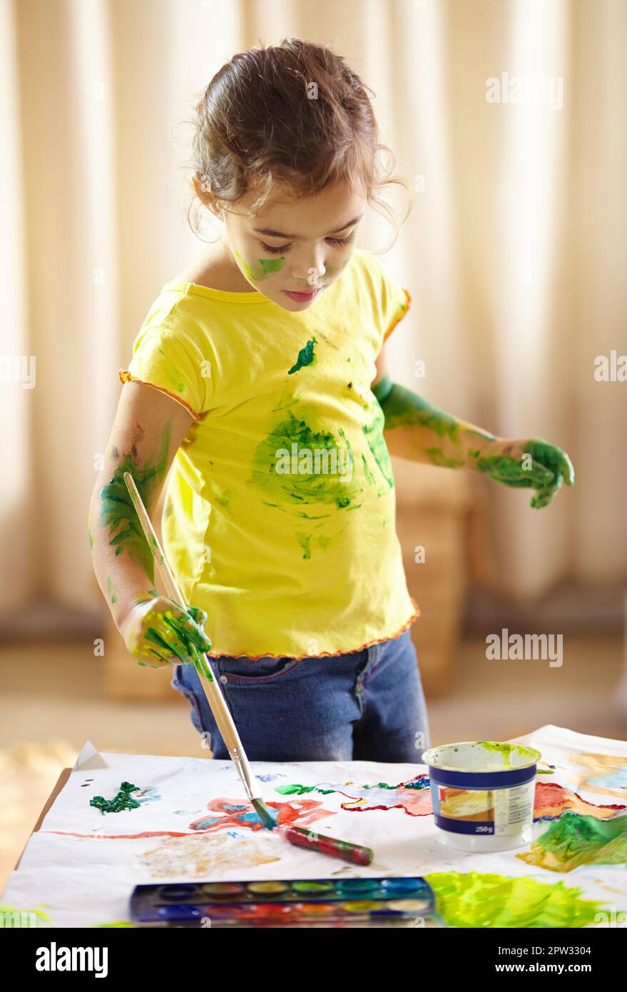 Time to make magic with this paint. an adorable little girl making a