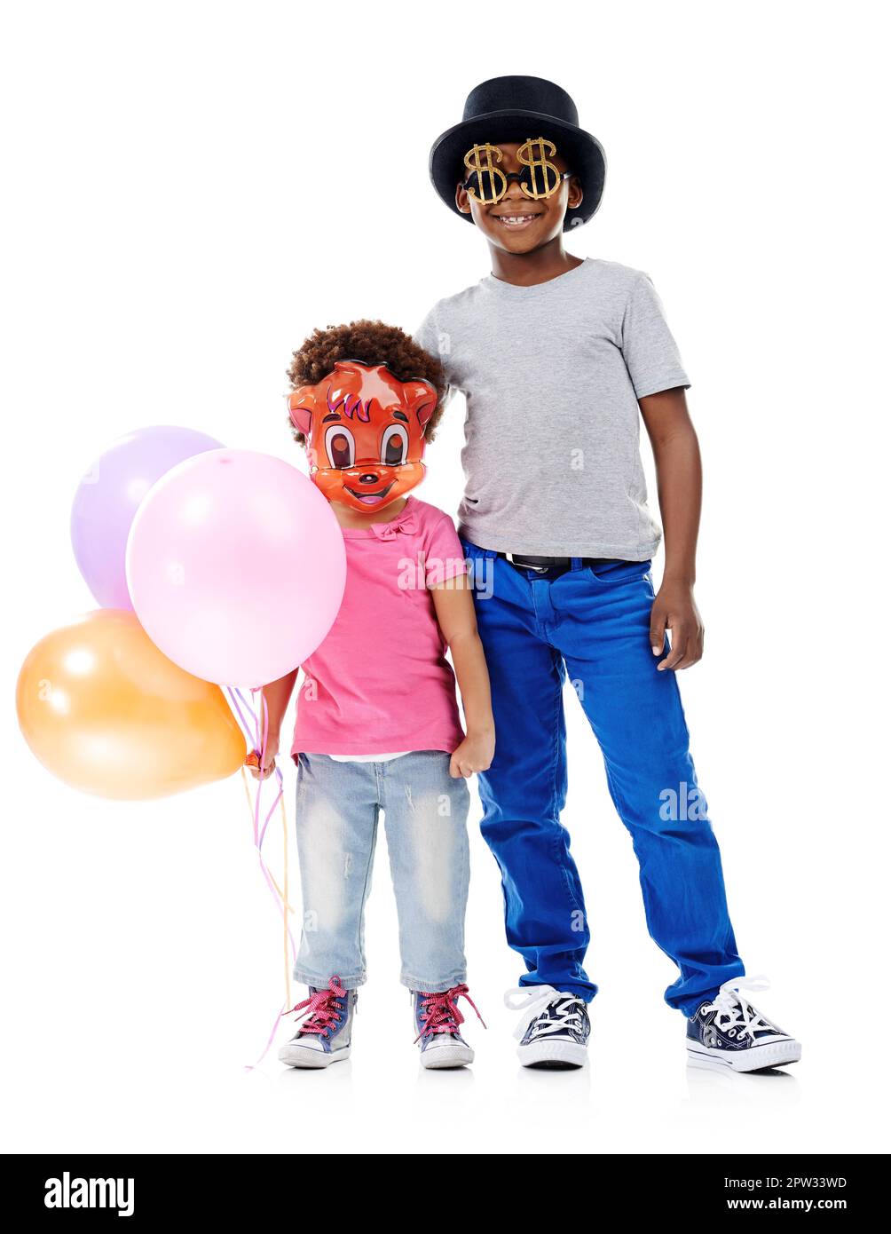 Fancy dress fun. Studio shot of two young friends dressed up for a party against a white background Stock Photo