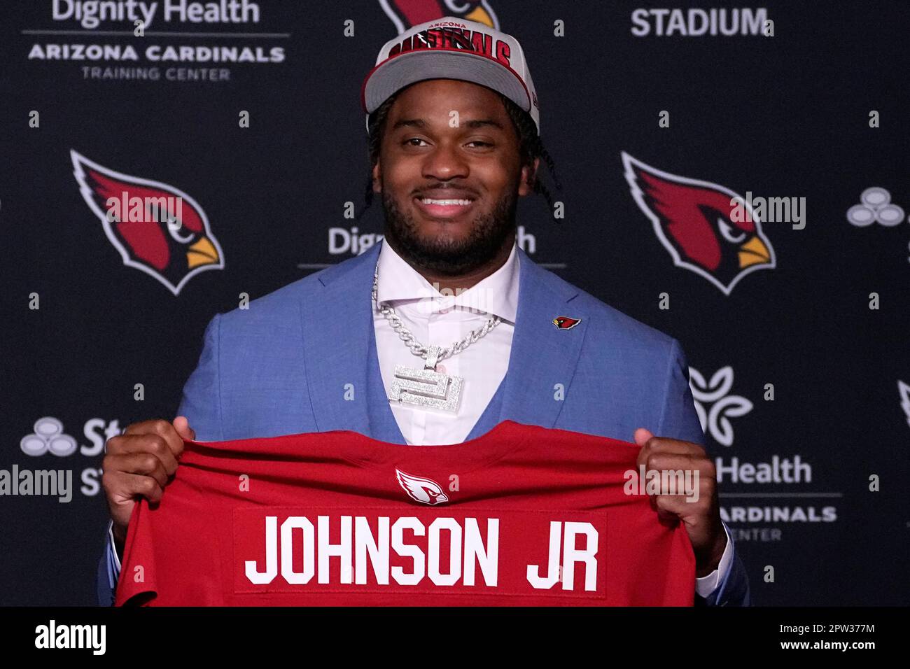 Arizona Cardinals firstround draft pick Paris Johnson Jr. hold up his