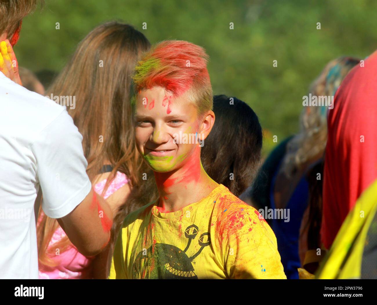 Boy covered in yellow powder paint hi-res stock photography and images