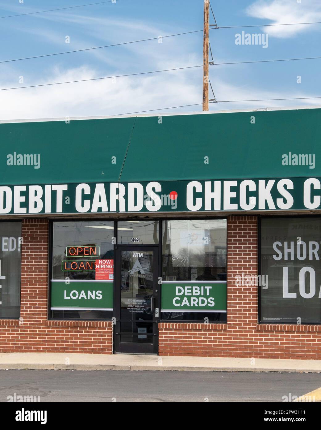 Storefront and entrance of a Loans, Debit Cards & Checks Cashed business, or fast cash, in Wichita, Kansas, USA. Stock Photo