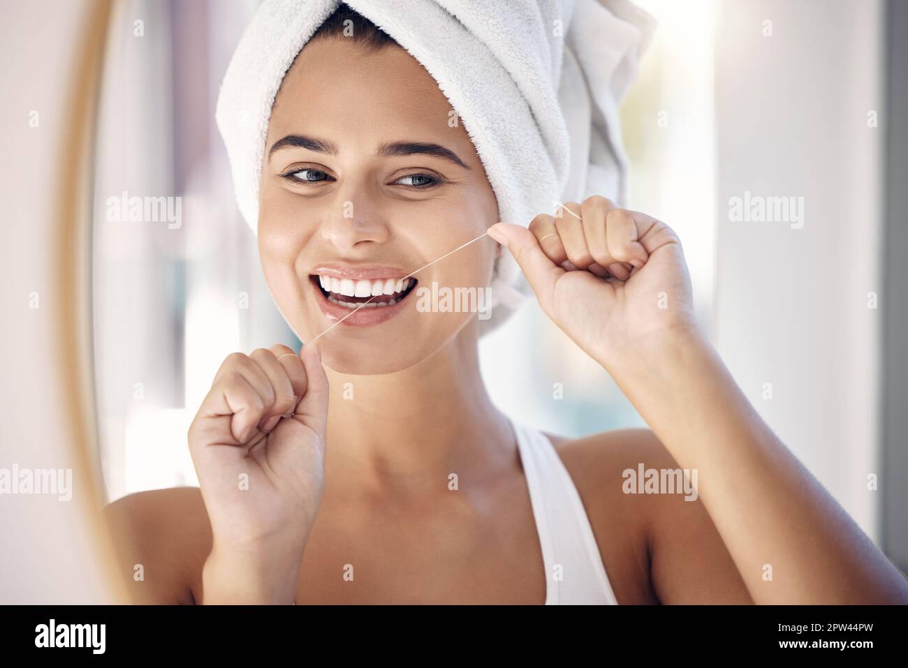 Dental floss, woman and teeth in bathroom mirror for tooth wellness