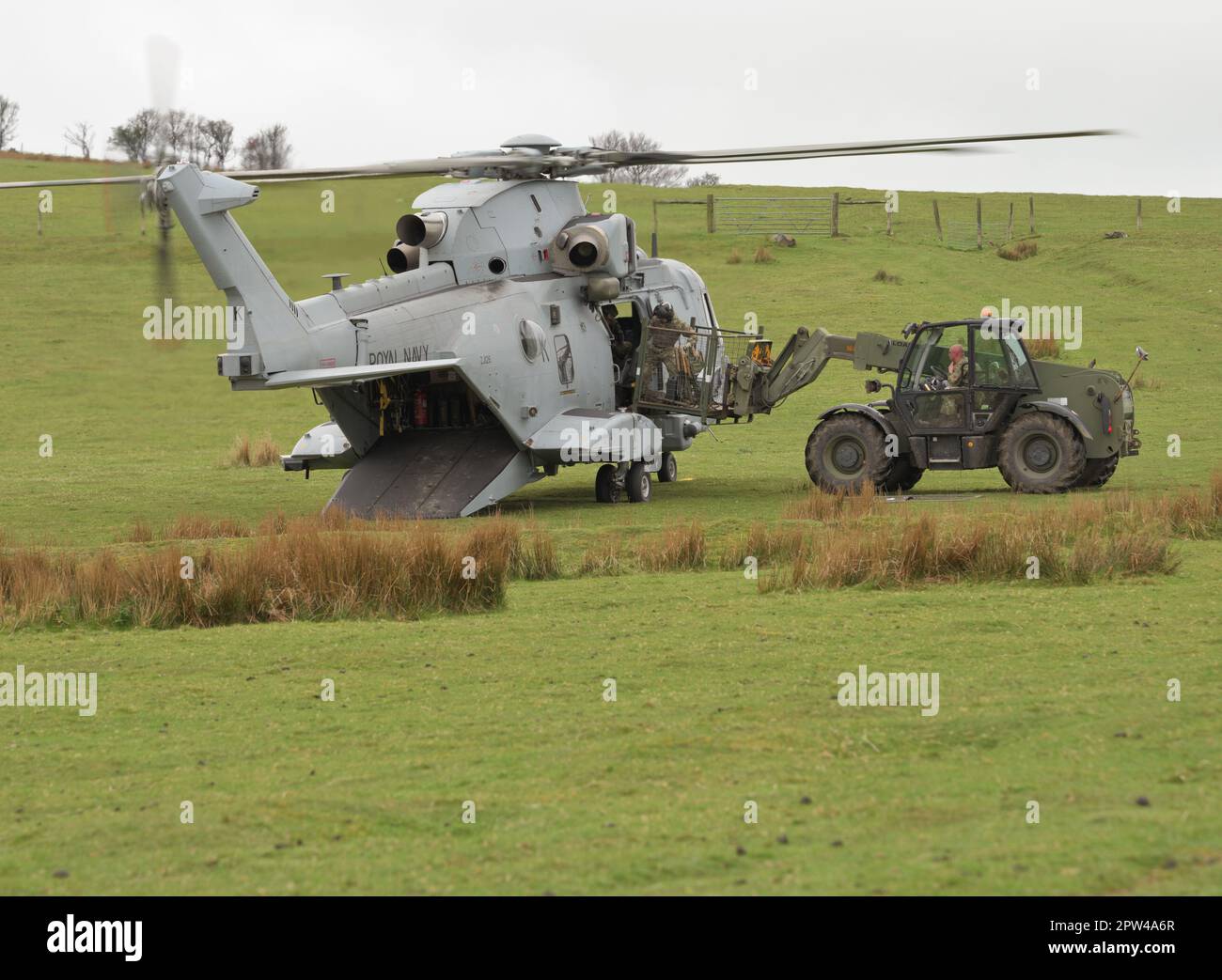 Equiment being loaded onto a Royal Navy Merlin Commando Helicopter. Oakhampton Camp, Dartmoor, UK. 28th April 2023 :Credit Bob Sharples/Alamy Live News Stock Photo
