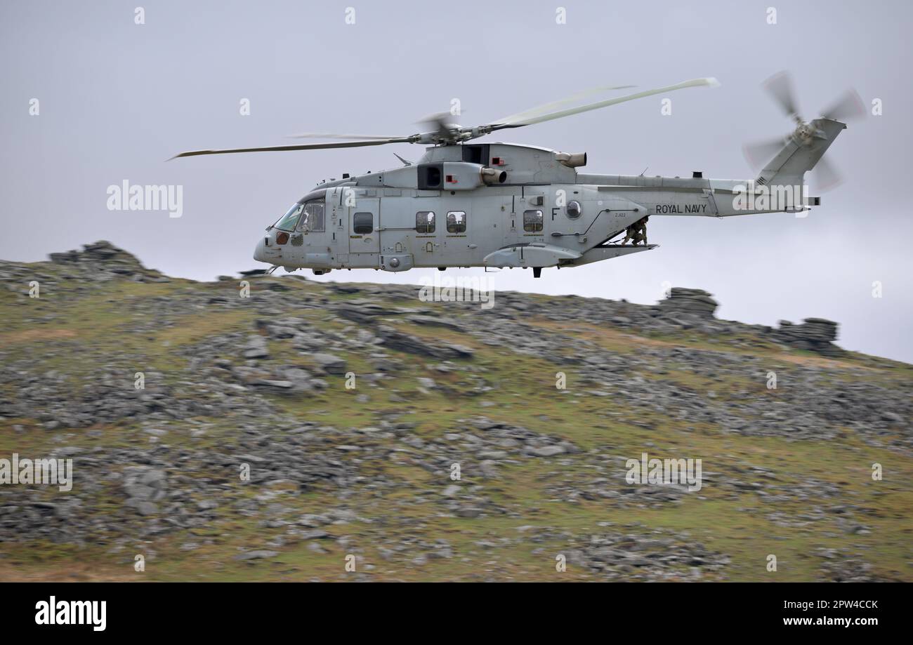 Royal Navy Merlin Commando Helicopter low flying over the rugged terrain of Dartmoor. Oakhampton Camp, Dartmoor, UK . 28th April 2023 :Credit Bob Sharples/Alamy Live News Stock Photo