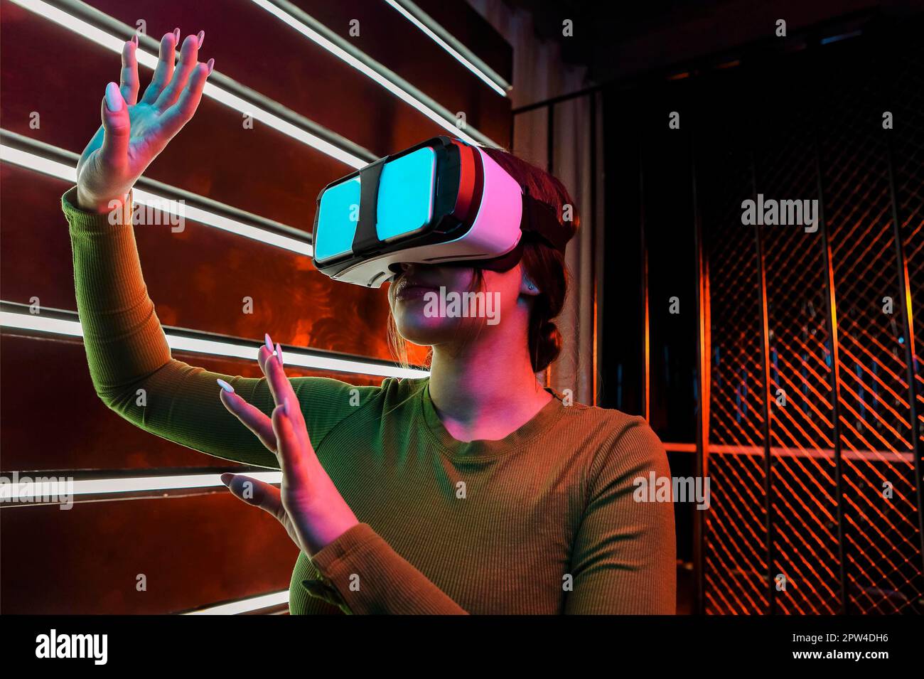 Happy female in VR headset smiling and exploring virtual reality under