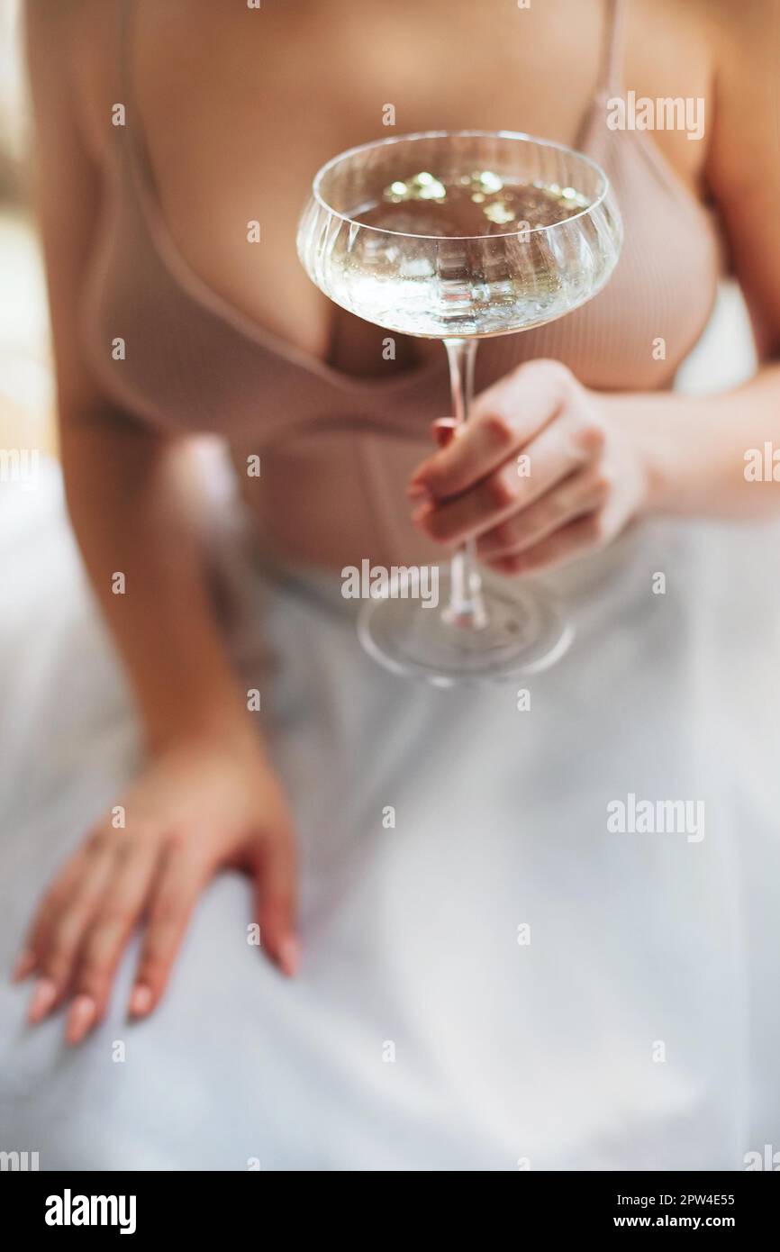 From above soft focus of anonymous woman with glass goblet of fizzing  champagne enjoying banquet Stock Photo - Alamy
