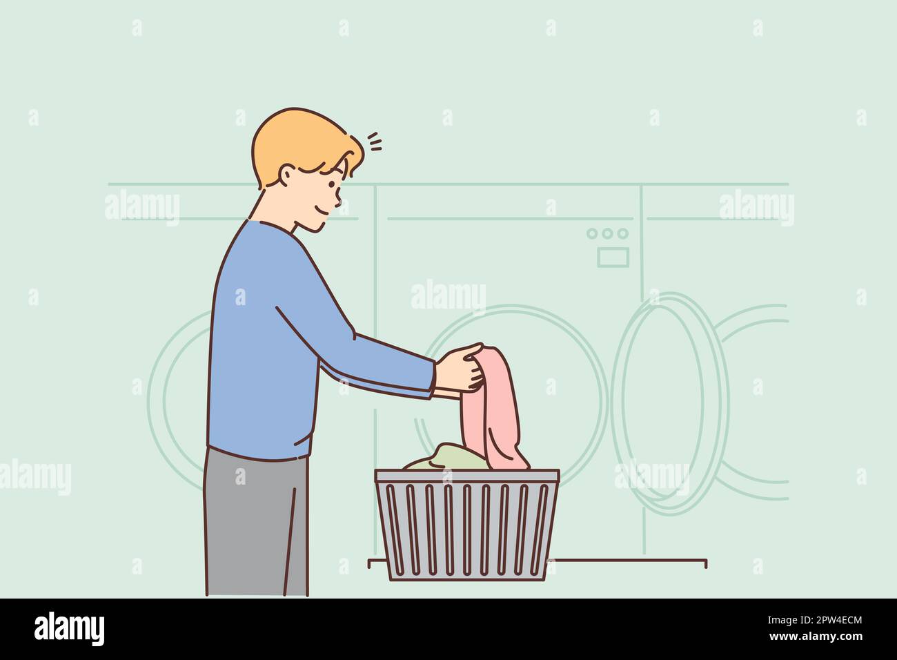 Young man washing clothes in laundry. Smiling guy with dirty clothing ...