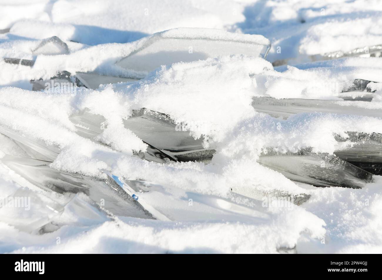 Big frozen ice cubes on an iced lake with snow and sunshine around Stock  Photo - Alamy