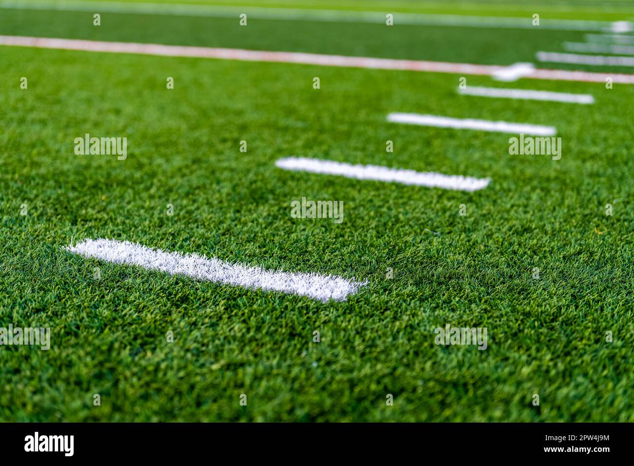Late afternoon close up photo of hash marks on a synthetic turf football field Stock Photo Alamy