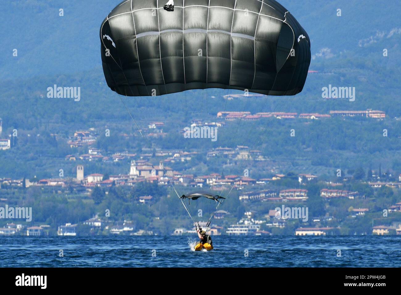A U. S. Army Paratrooper assigned to 173rd Airborne Brigade, conducts a water jump after into Lake Garda near Pacengo, Italy, Apr. 26, 2023. The 173rd Airborne Brigade is the U.S. Army Contingency Response Force in Europe, capable of projecting ready forces anywhere in the U.S. European, Africa or Central Commands' areas of responsibility. (U.S. Army photo by Paolo Bovo) Stock Photo