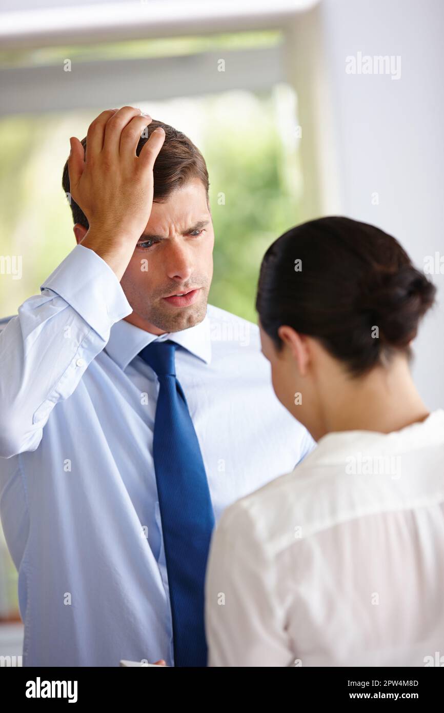 He finally understood the term dumbstruck. two business colleagues having a discussion Stock Photo