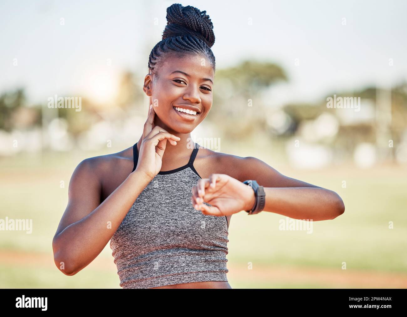 Fitness, exercise and black woman check pulse after running, athletics and workout in sports stadium. Health, wellness and portrait of female athlete Stock Photo