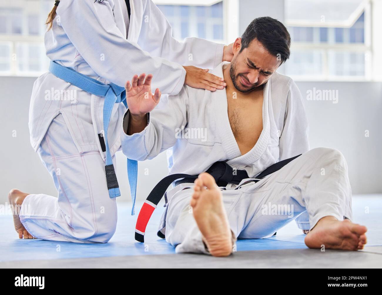Karate, sports and neck injury pain of fighter on floor with surrender