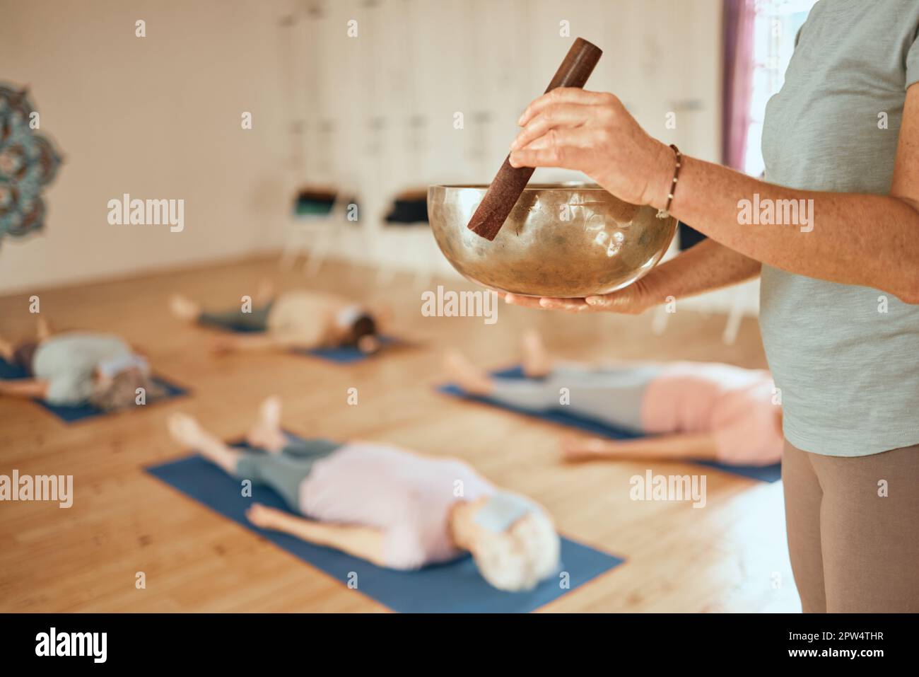 Yoga, class and woman with Tibetan singing bowl for meditation, calm