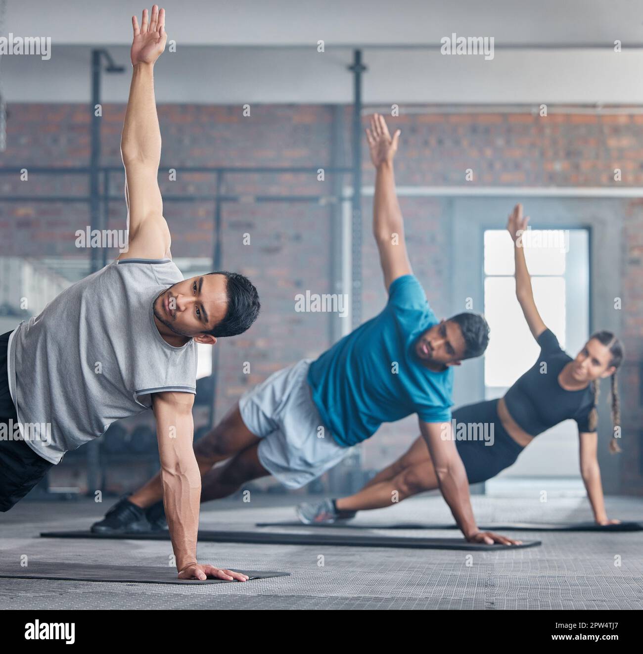 People workout in gym, group exercise in fitness club and together on