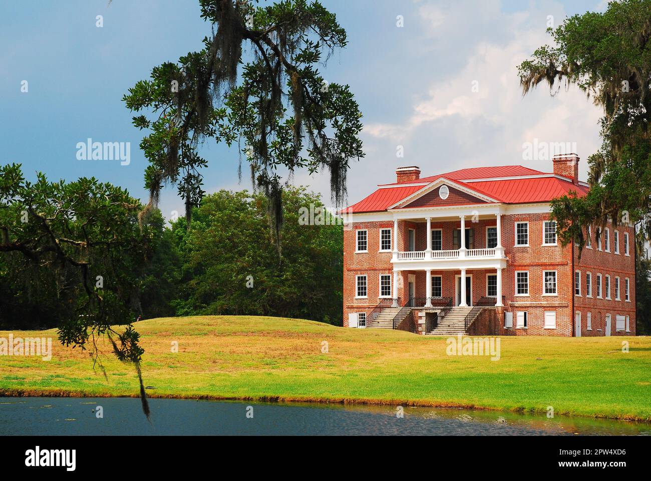 Spanish moss from a tree hangs and frames the historic Drayton Hall, in