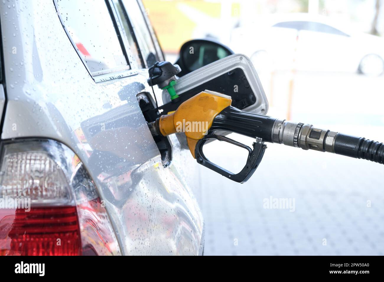 Filling gasoline to the car with gas pump. Stock Photo