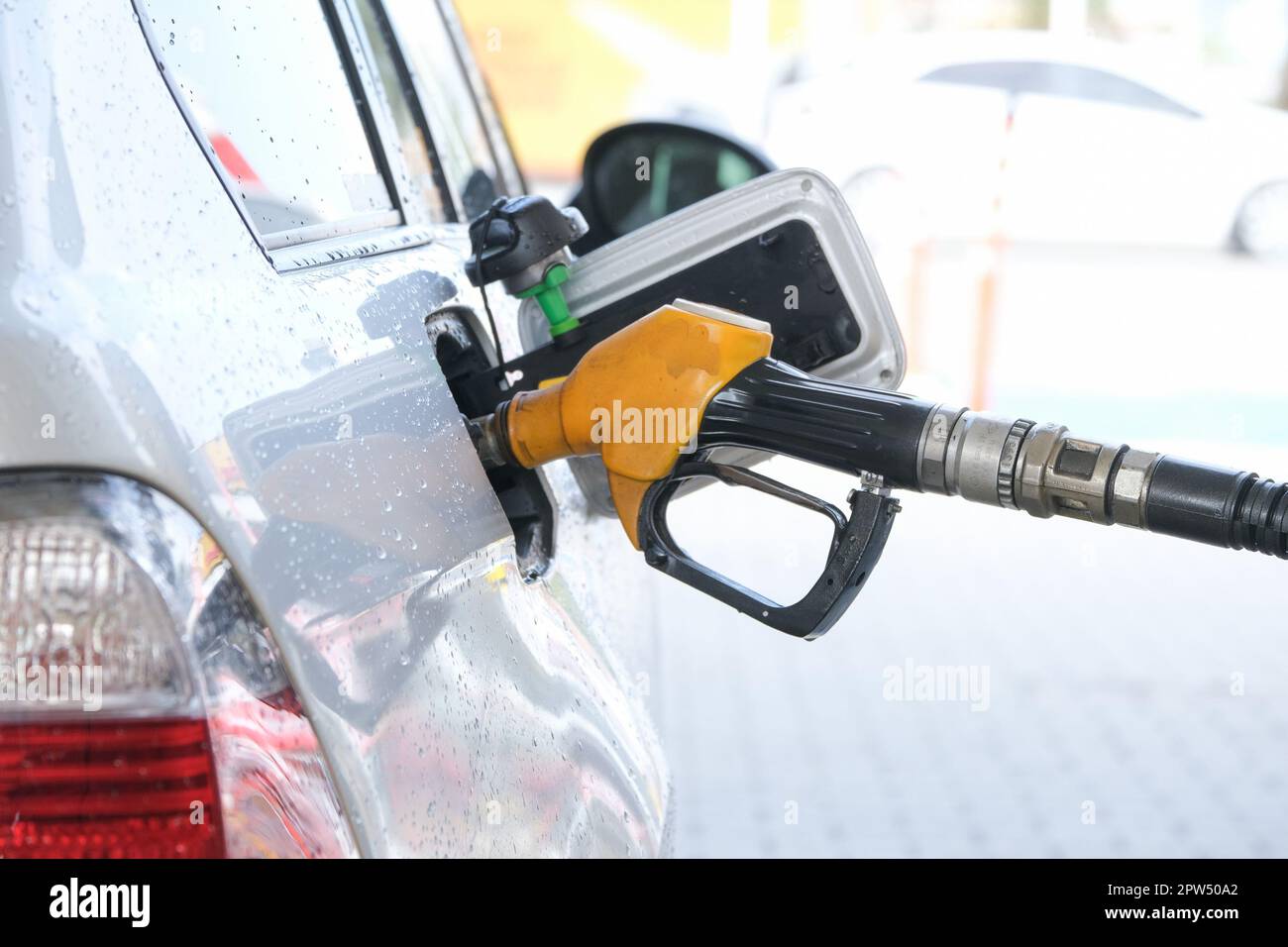 Filling gasoline to the car with gas pump. Stock Photo