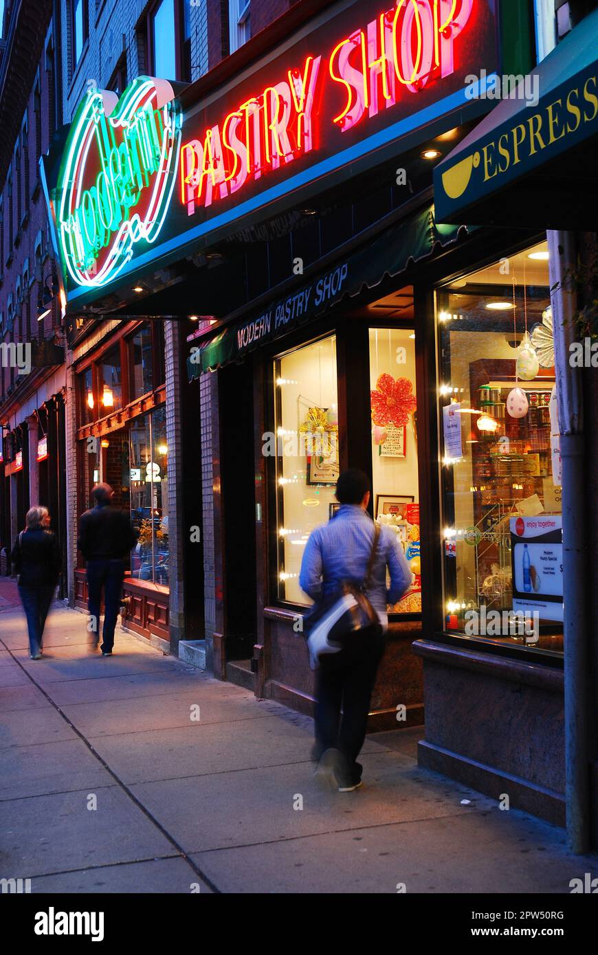 An adult man walks into Modern Pastry Shop, a Landmark bakery in Boston