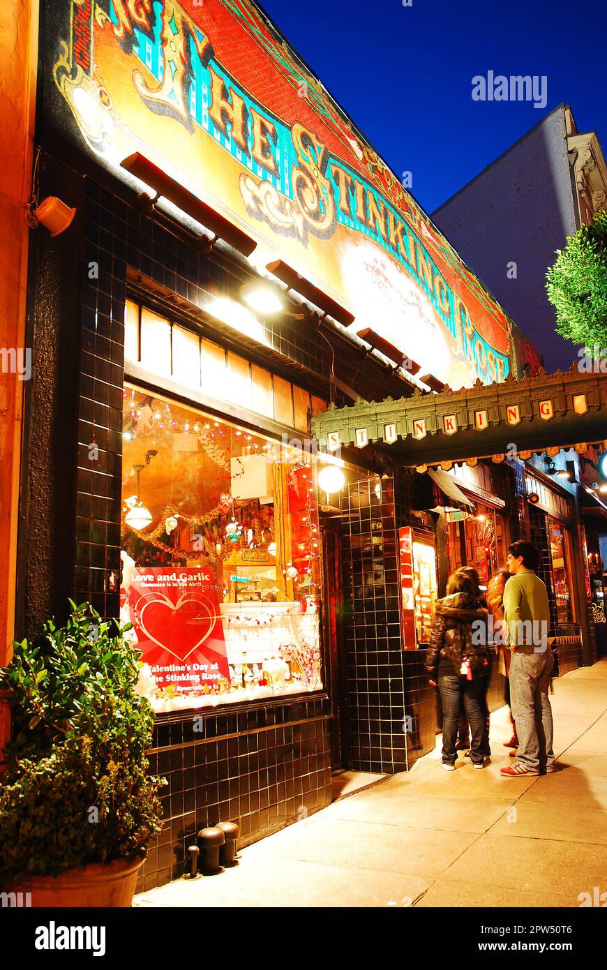Friends enter the Stinking Rose restaurant, an Italian restaurant in