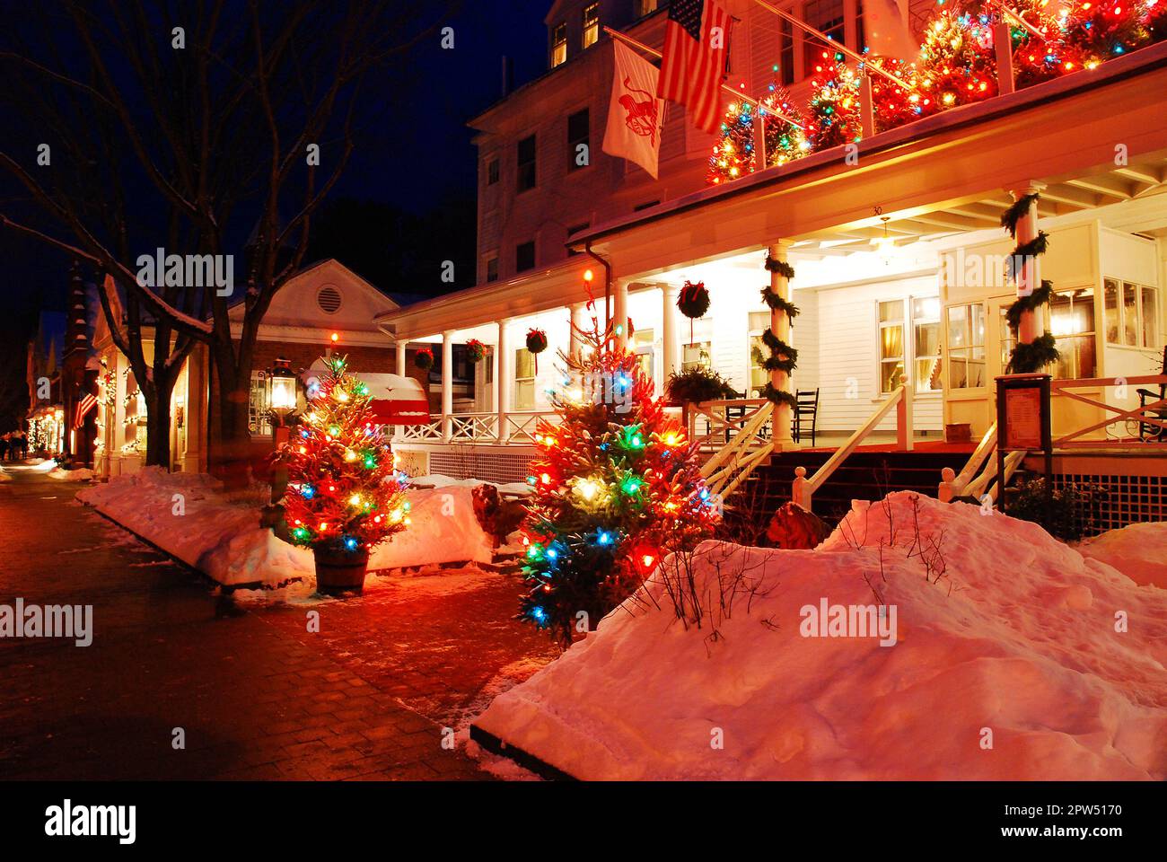 Christmas lights decorate a country inn on a snow covered winter night in New England Stock Photo