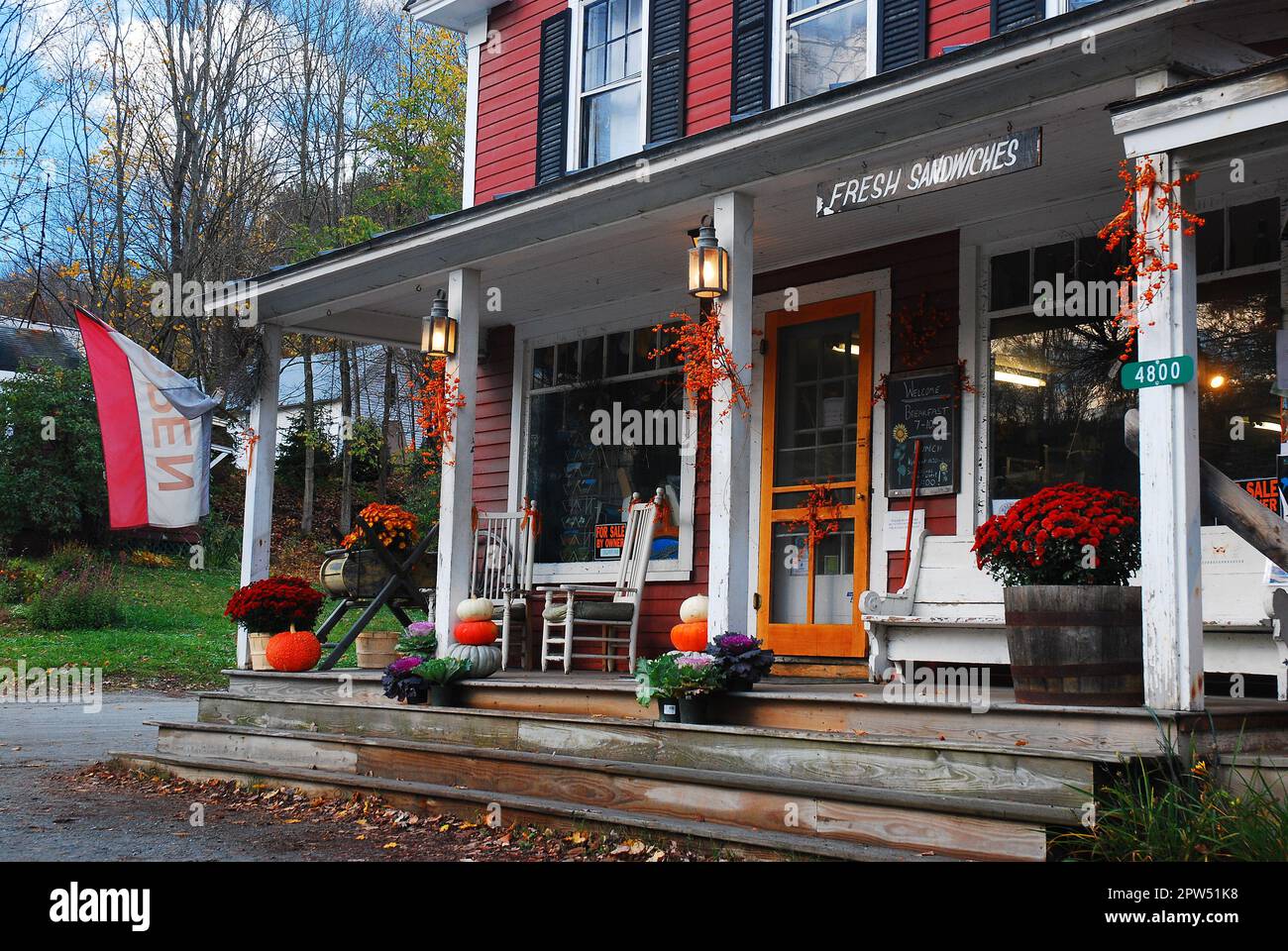 The South Woodstock General Store in Vermont is decorated with mums flowers and pumpkins on an autumn day in New England Stock Photo