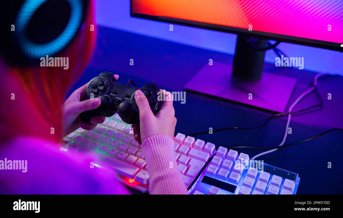 Gamer using joystick controller for virtual tournament plays online