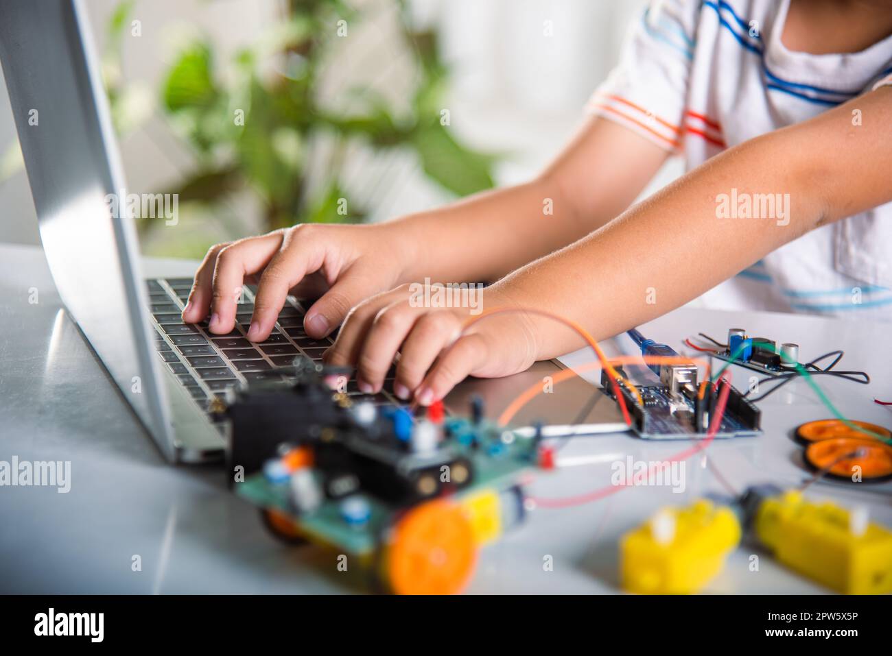 Asian kid boy learns coding and programming with laptop for Arduino ...