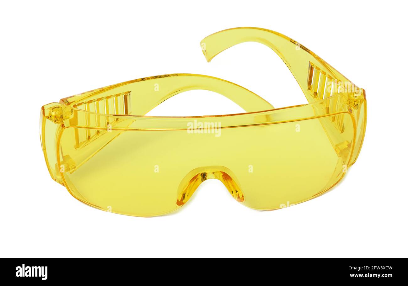 Yellow plastic protective goggles for workers on a white isolated background Stock Photo