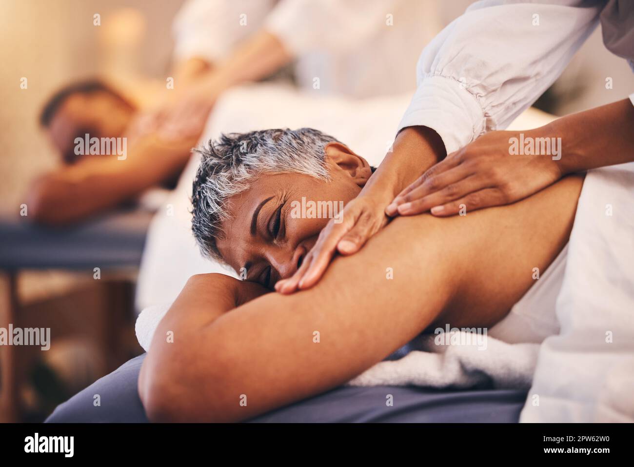 Couple at spa for massage, therapist hands and relax, wellness and holistic  health with peace, zen and skincare. Beauty salon, luxury service with tre  Stock Photo - Alamy