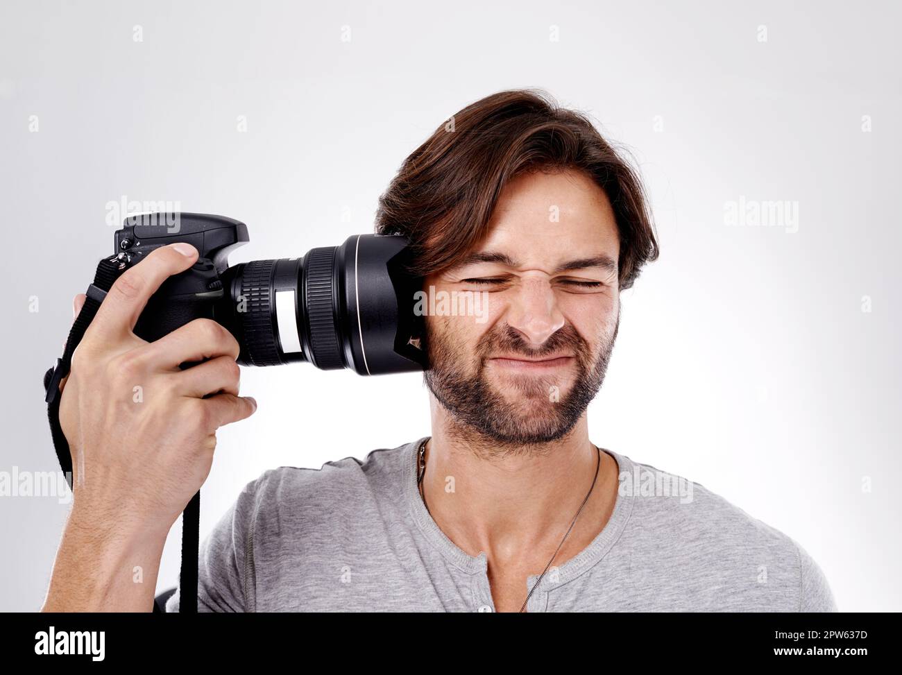Shoot yourself. A young photographer pressing his camera against his