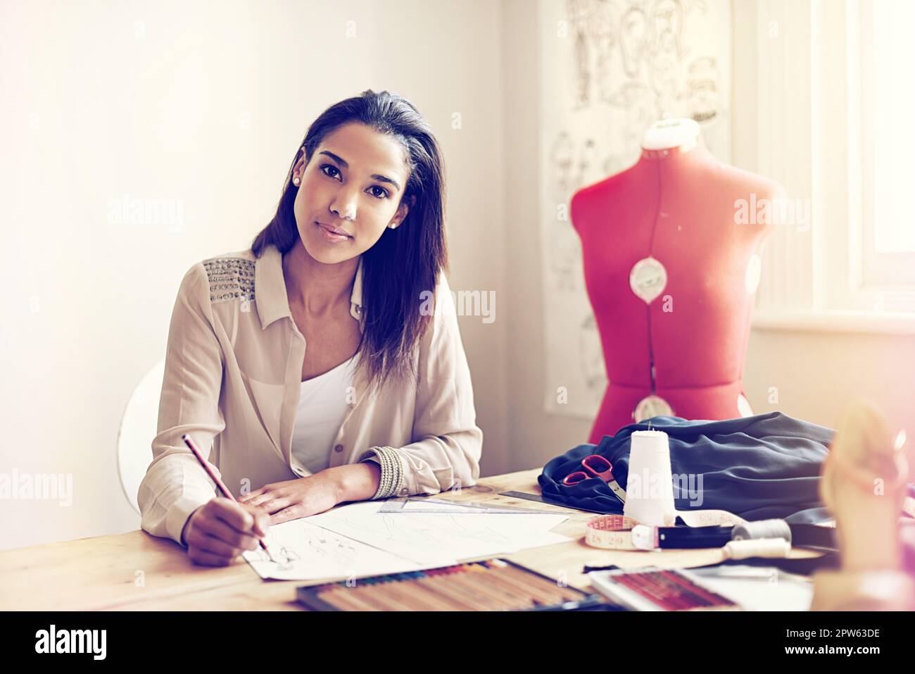 Take a look at the future of fashion. a young fashion designer working ...