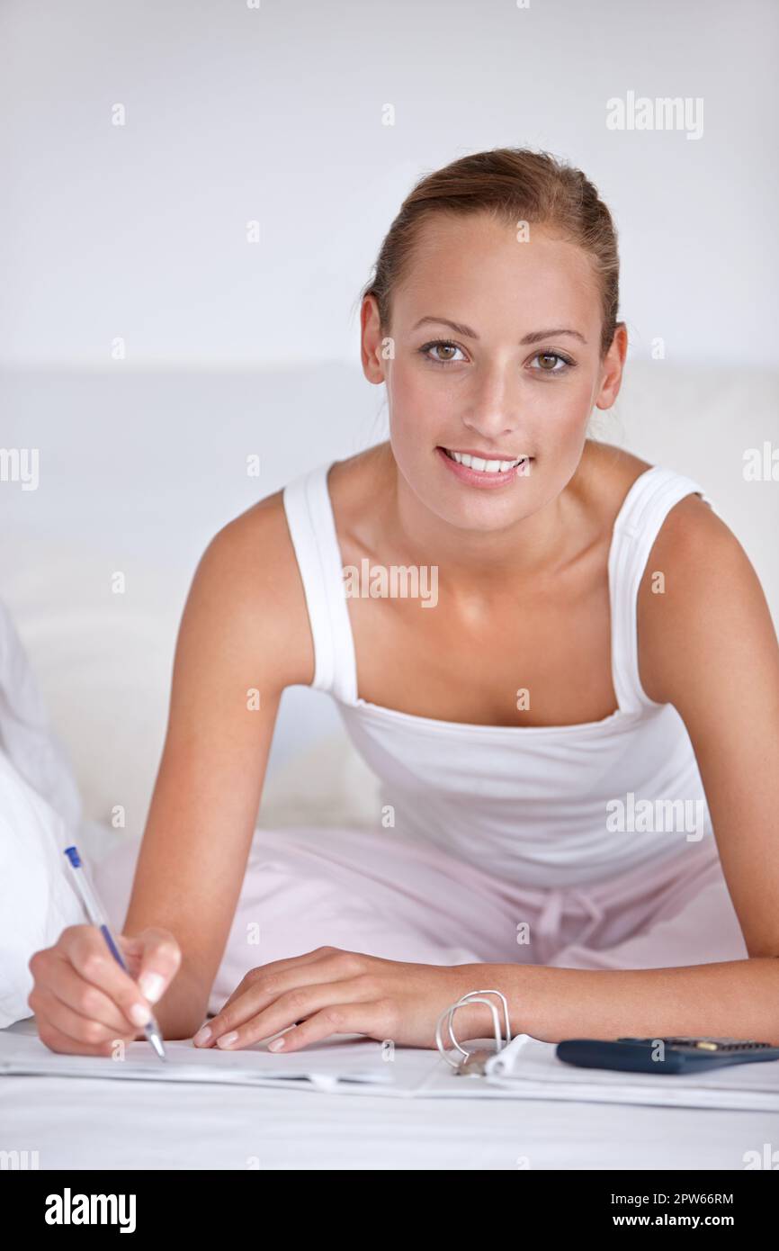 Adding a diary entry. A young woman planning her monthly financial