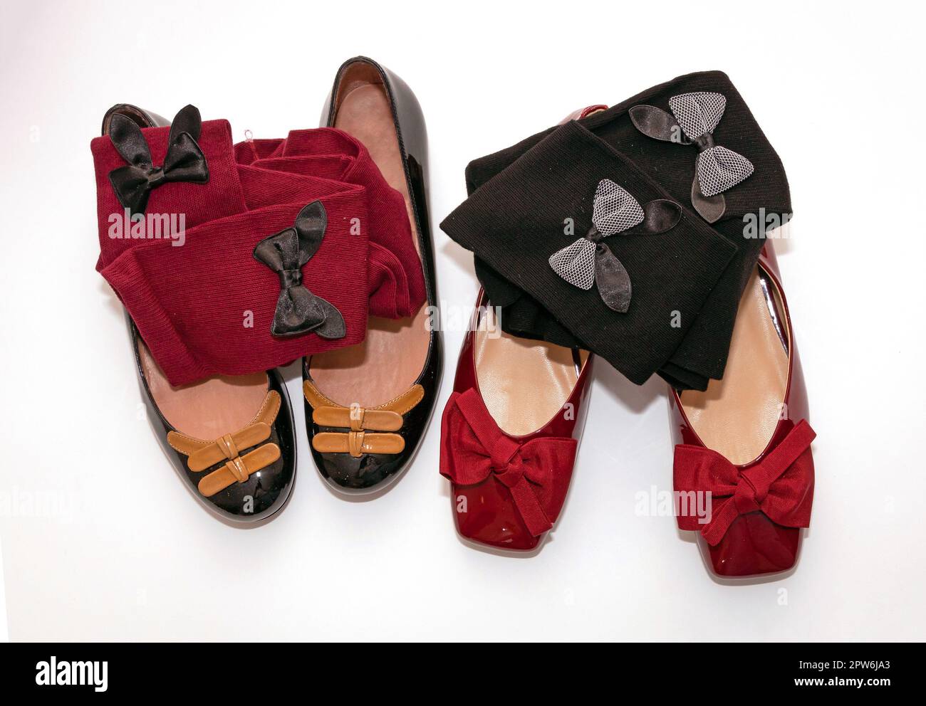 Elegant female flat ballerina patent leather shoes with decorative bow socks isolated on white background Stock Photo