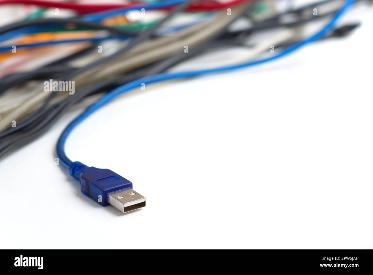 Data transfer computer connector with tangled cables on white background. Tech support, network infrastructure concept. Stock Photo