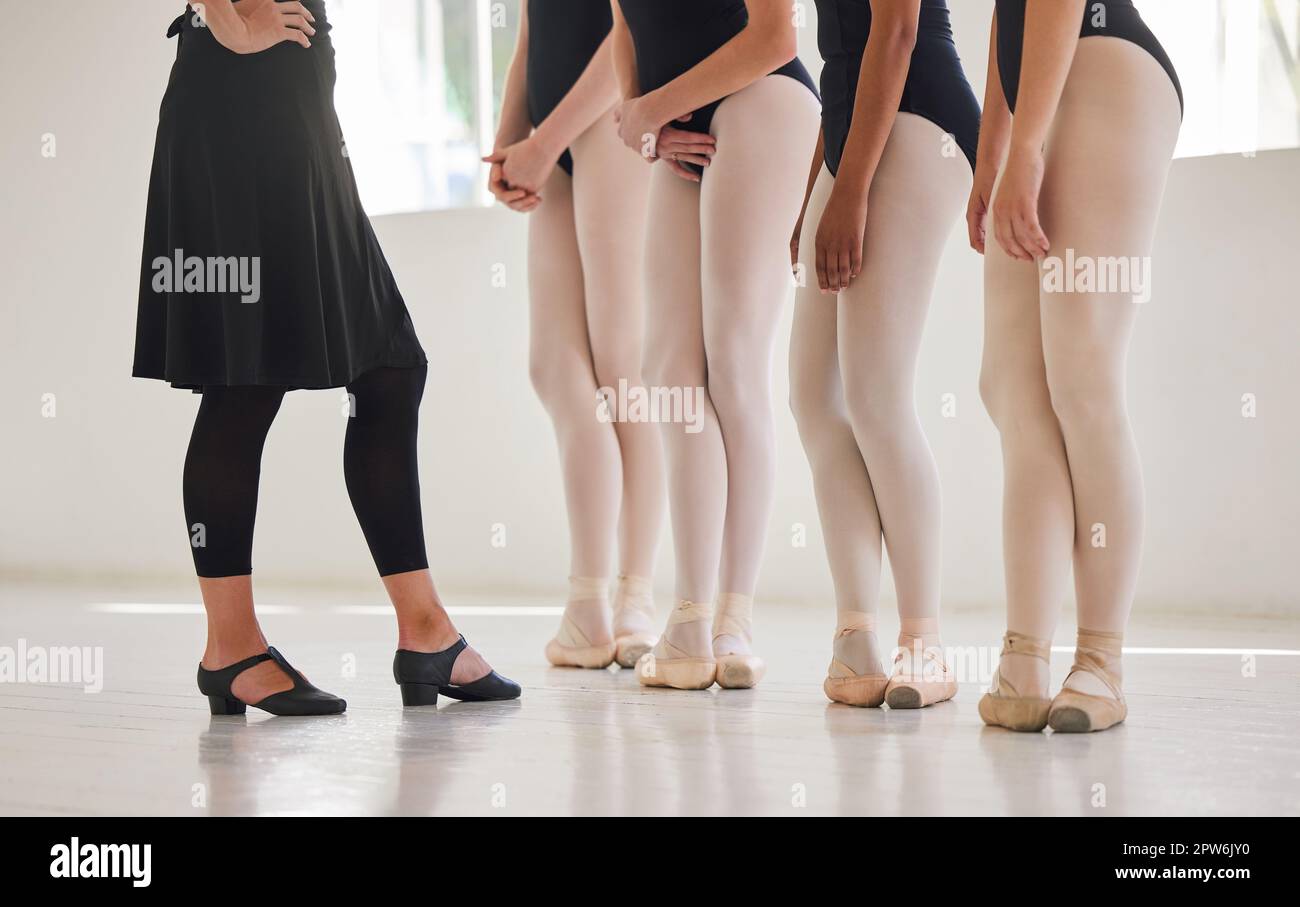 Ballet education, feet and dance students standing in line with teacher. Discipline, posture and commitment to dancing school practice. Coach and youn Stock Photo