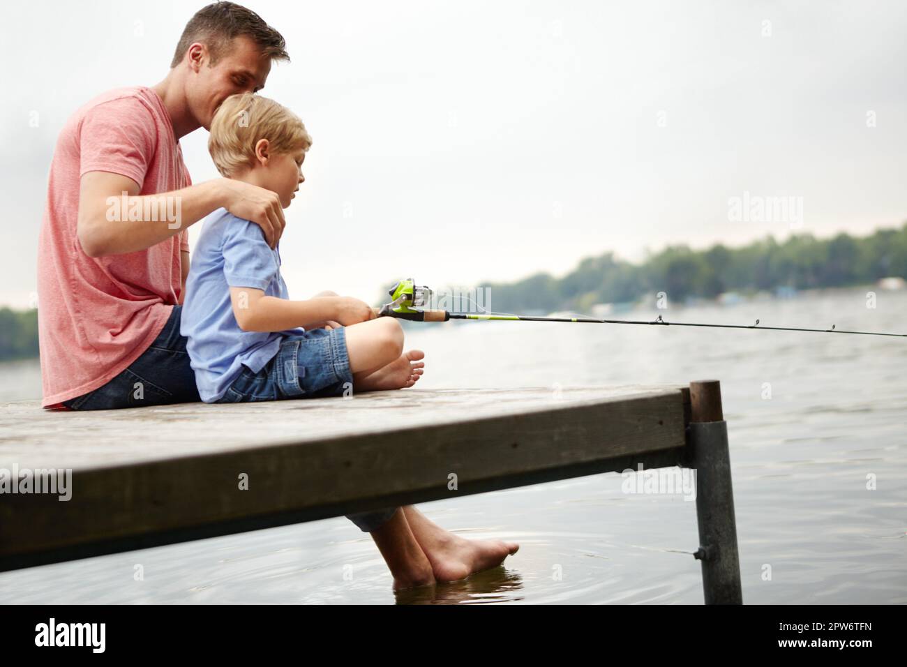 Teaching my son how to catch a fish. A father teaching his son how to