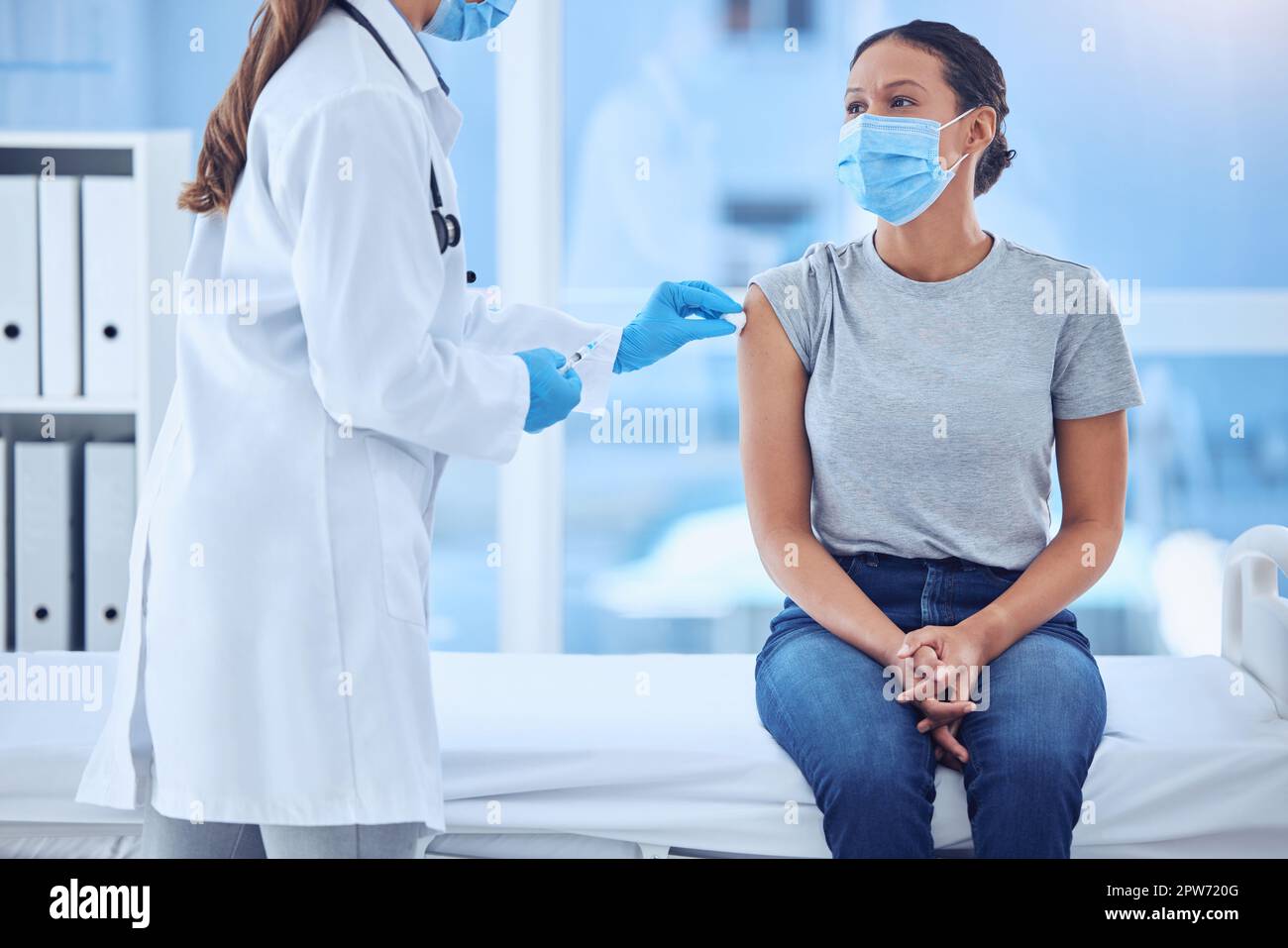 Doctor using cotton to clean the arm of a patient. Doctor giving a