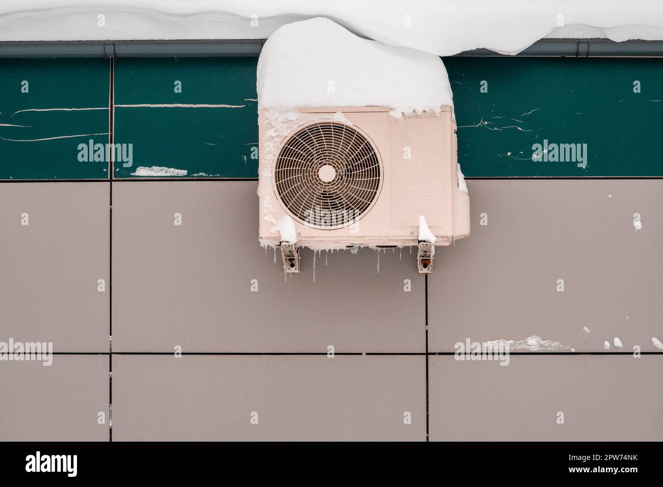 An outdoor air conditioner unit installed on the outer wall of a