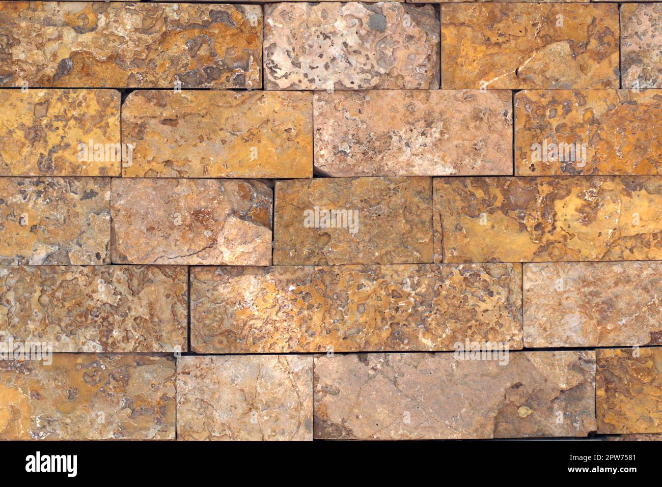 Rust-colored sandstone wall. Natural, rustic style construction. Stock Photo