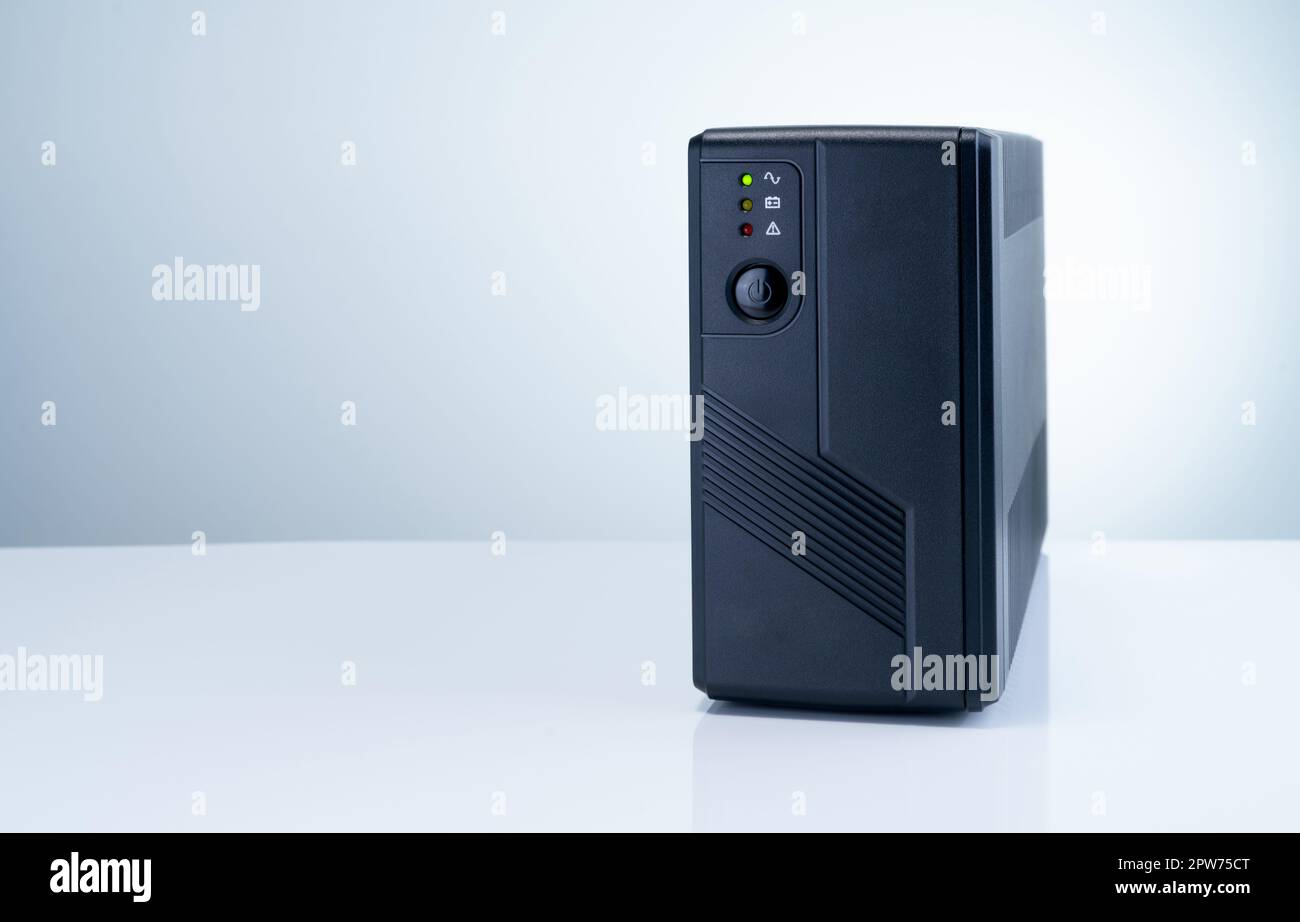 Uninterruptible power supply on white background. Backup Power UPS with battery. UPS with stabilizer for home PC. UPS inverter. Equipment for computer Stock Photo