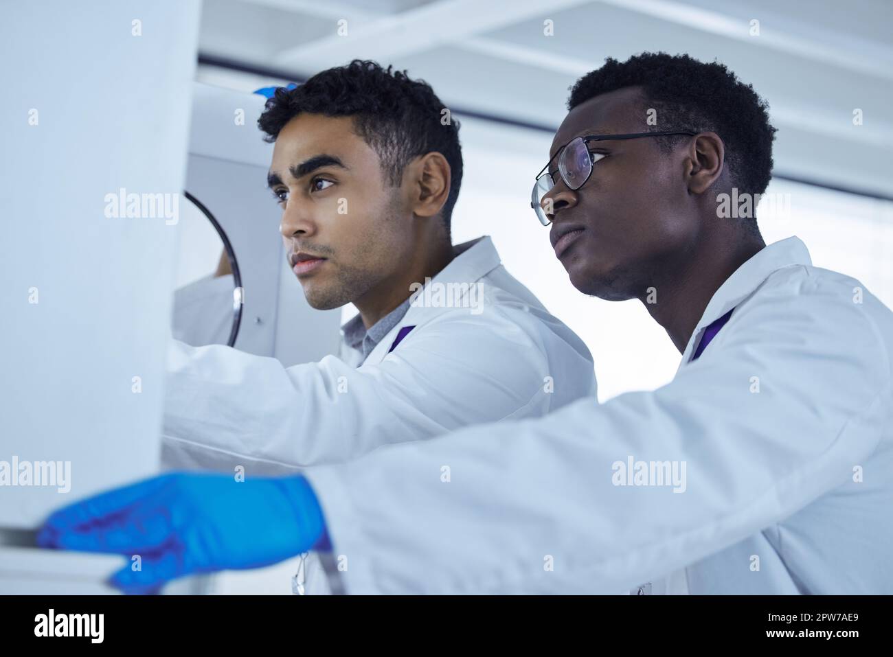 Not every hero wears a cape. two lab workers removing samples from a