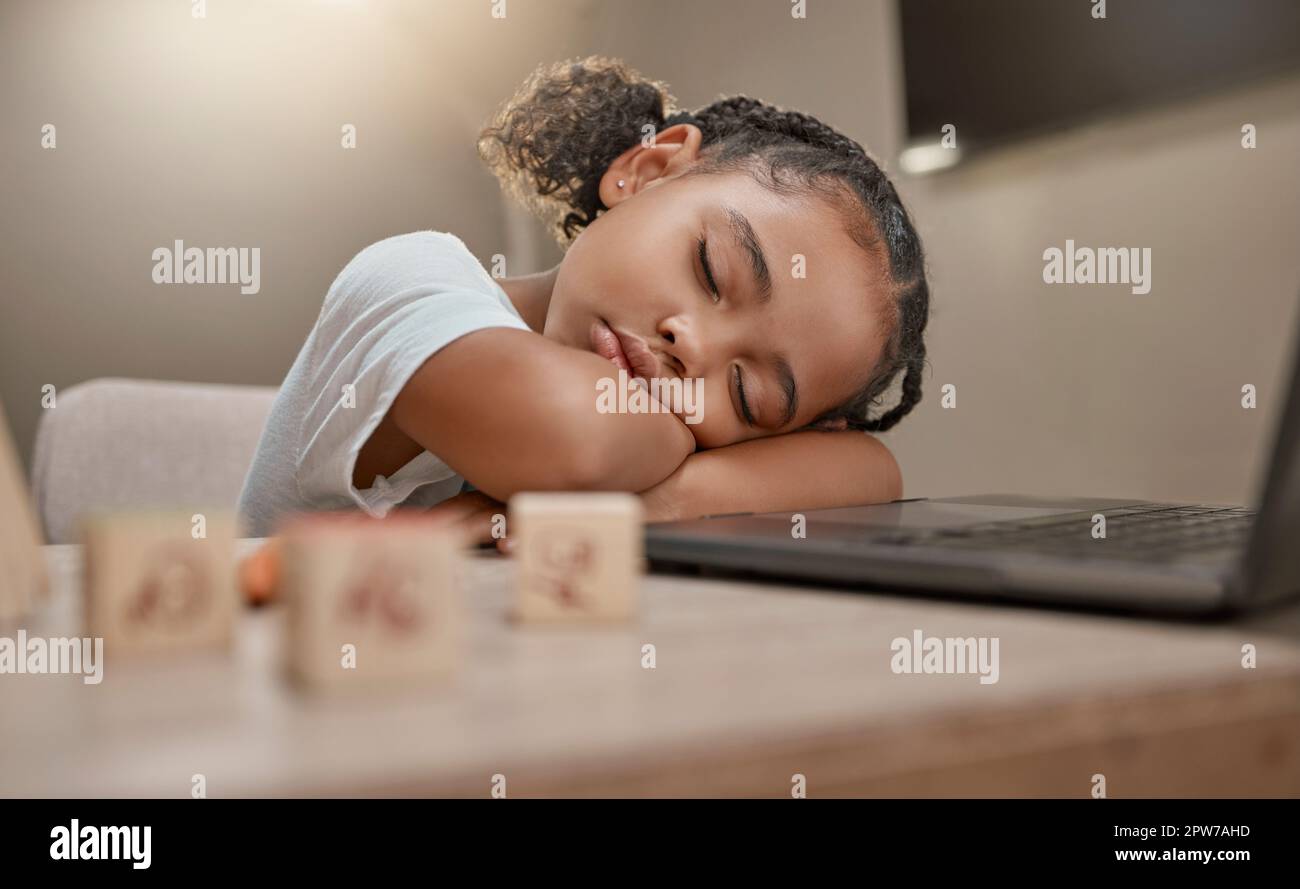 Child sleeping, learning and girl tired from home education, computer and kid development. Study, sleep and online education of a student in a house r Stock Photo