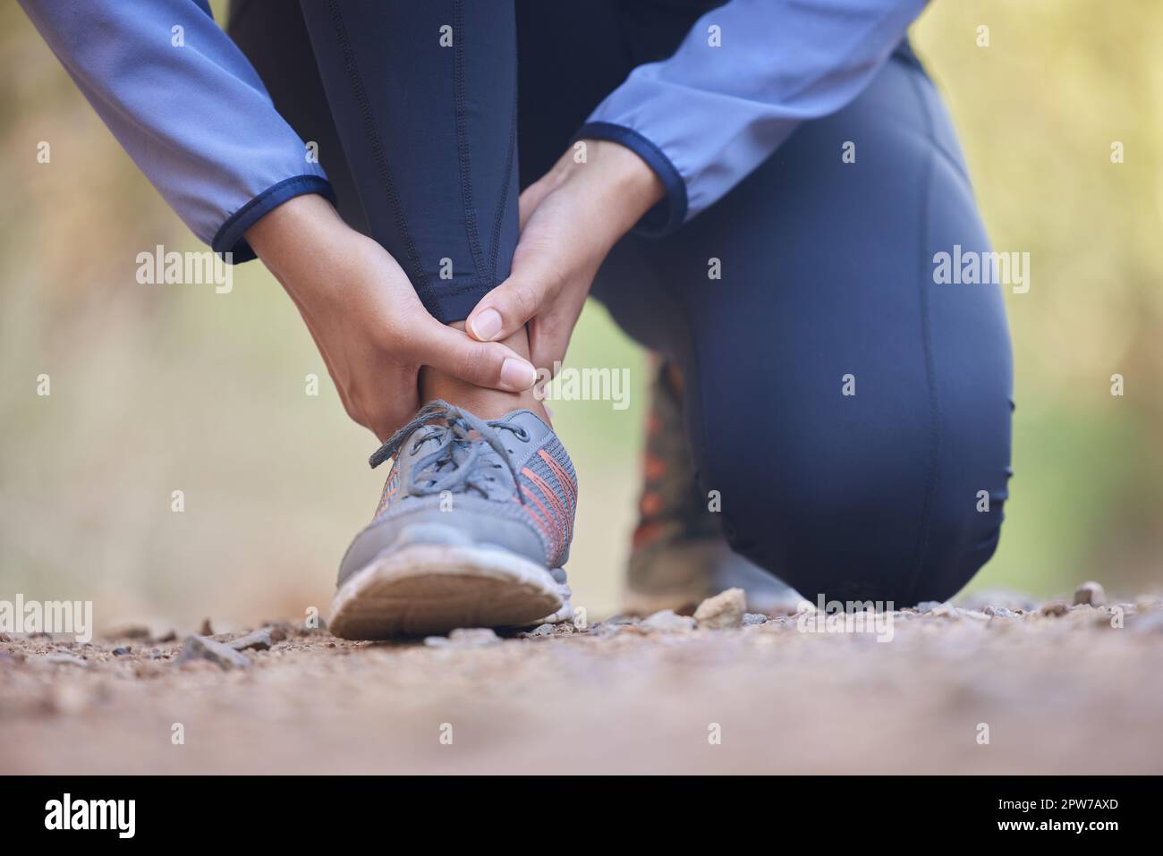 Running, ankle pain and injury with shoes of black woman on nature