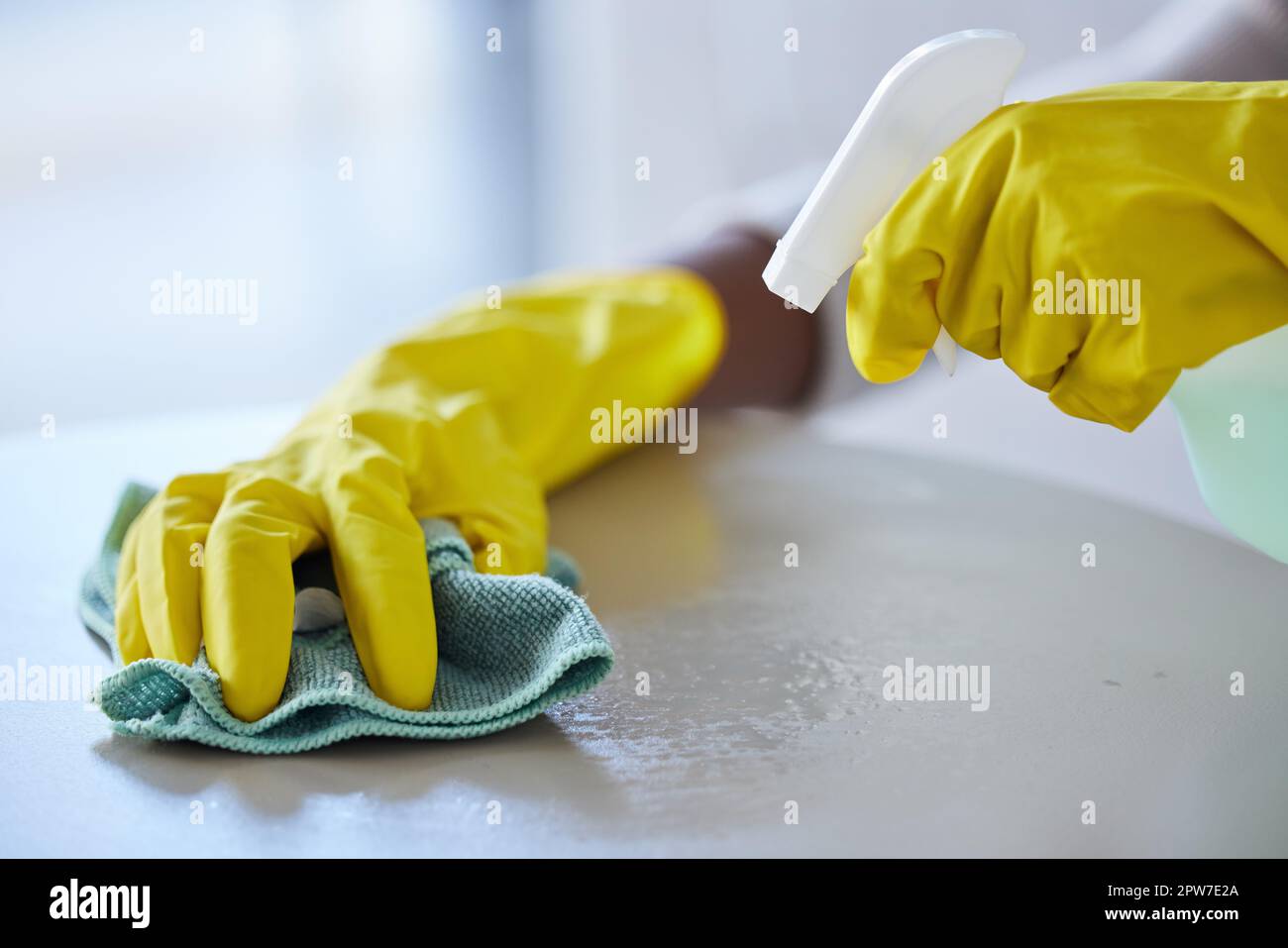 Cleaning, housekeeping and hands with cloth and spray bottle to wipe