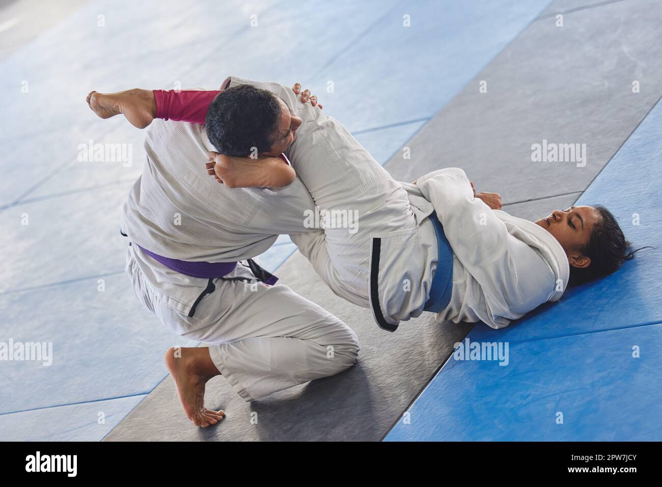 Full length shot of two young martial artists practicing jiu jitsu in