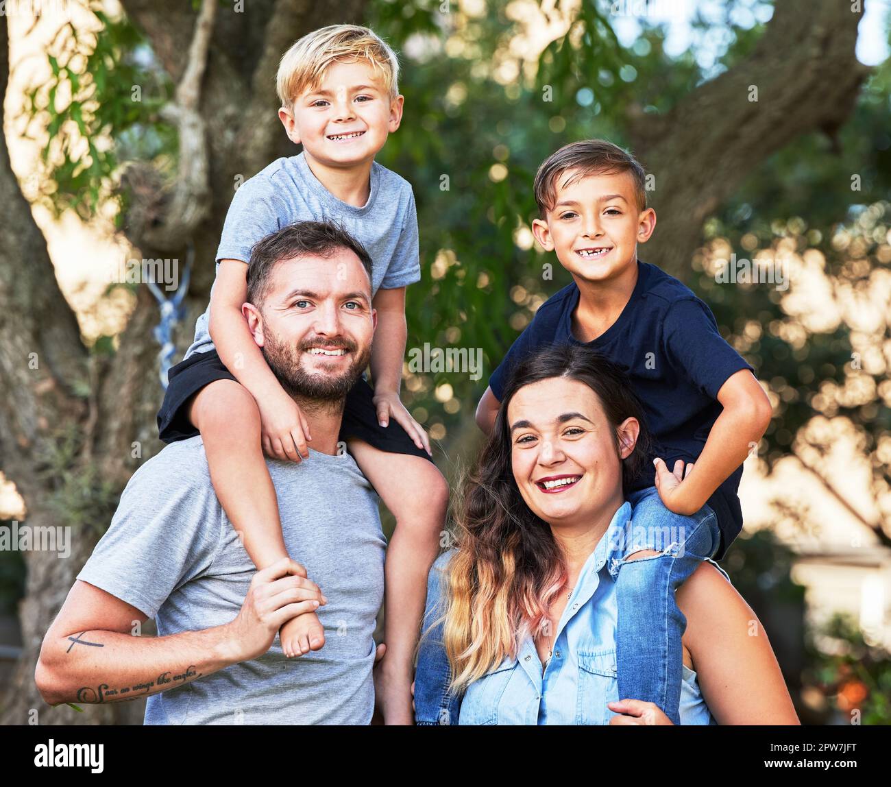 Portrait of a beautiful family with their sons on their shoulders in a