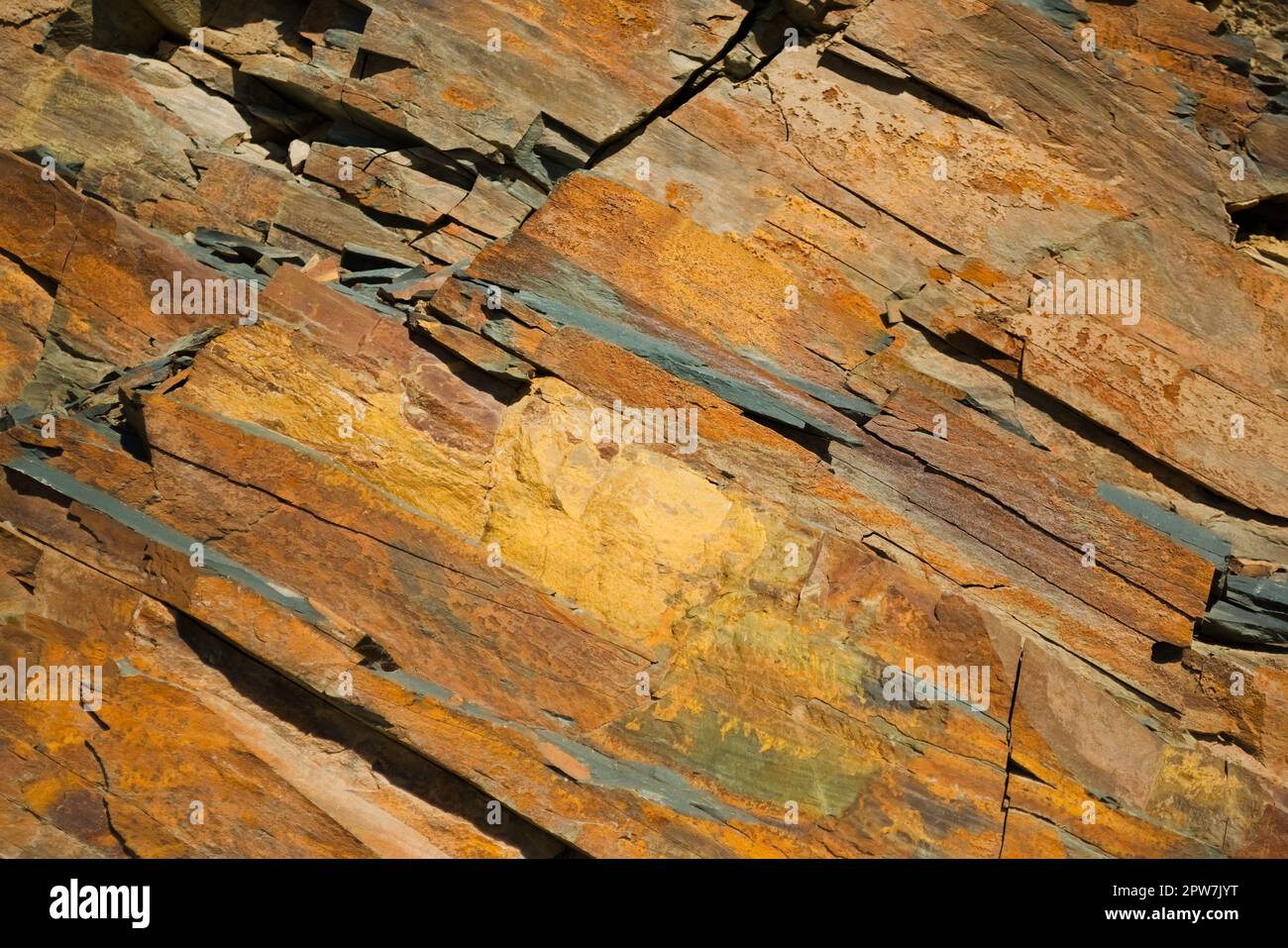 Reddish layered rock wall, with visible geological strata in the Andes ...