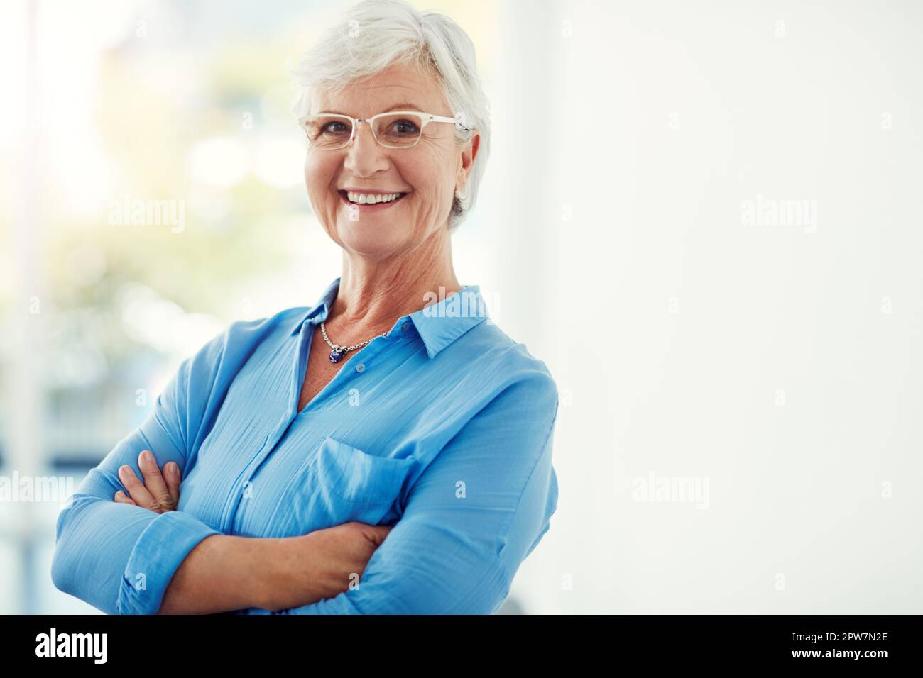 Confidence grows with age. Cropped portrait of a senior woman standing with her arms folded at home. Stock Photo