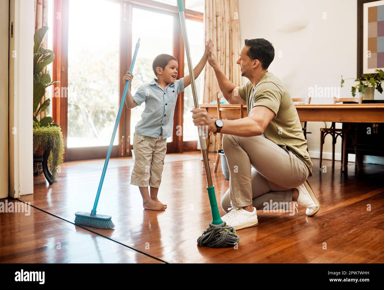 Young child doing house chores at home. Asian baby boy sweeping floor with  broom Stock Photo - Alamy